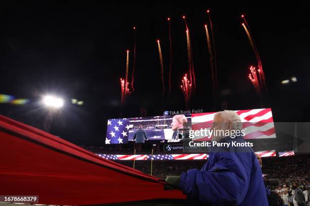 Person holds an American flag during the national anthem prior to an AFC Wild Card playoff game against the Los Angeles Chargers at TIAA Bank Field...