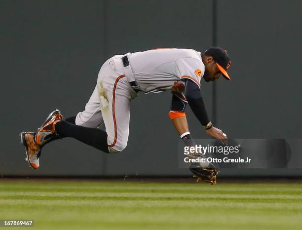 Center fielder Adam Jones of the Baltimore Orioles misses the ball, allowing a single by Kyle Seager of the Seattle Mariners in the sixth inning at...