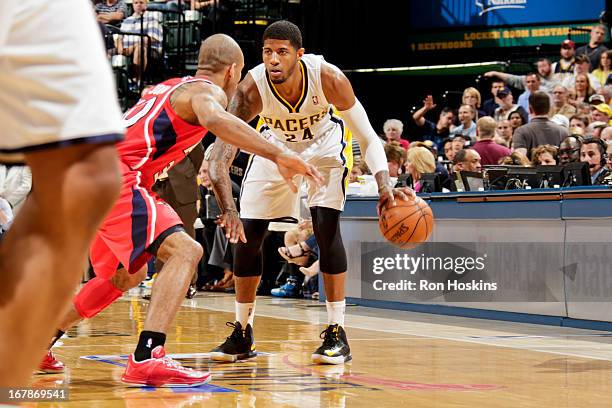 Paul George of the Indiana Pacers controls the ball against Dahntay Jones of the Atlanta Hawks in Game Five of the Eastern Conference Quarterfinals...