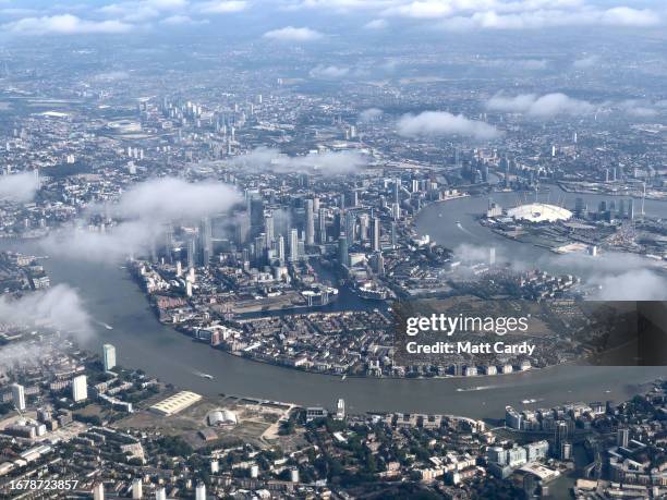 Buildings in the financial district of the capital are seen besides the River Thames, viewed from the air on September 11, 2023 in London, England.