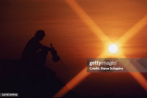 Silhouette of Norwegian actor Tutte Lemkow pictured against a sunset in a scene from the film 'Fiddler on the Roof' , 1970. The film was released the...