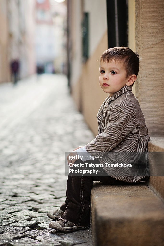 Boy, sitting on a doorstep