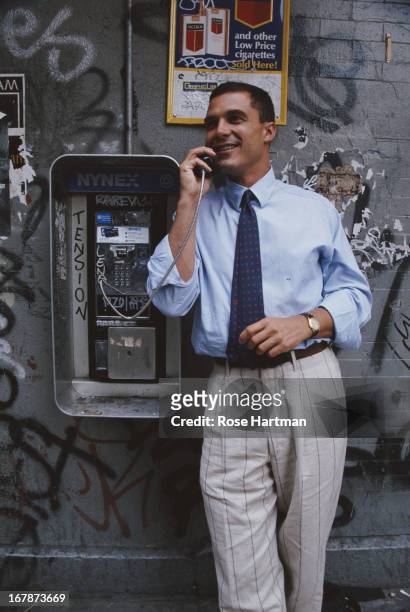 Andre Balazs, President and CEO of Andre Balazs Properties posing with a public telephone, circa 1996.