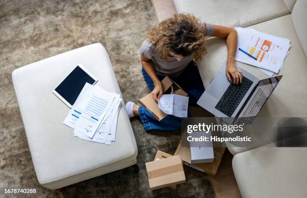 entrepreneur working on her e-commerce business managing online orders - classification stock pictures, royalty-free photos & images