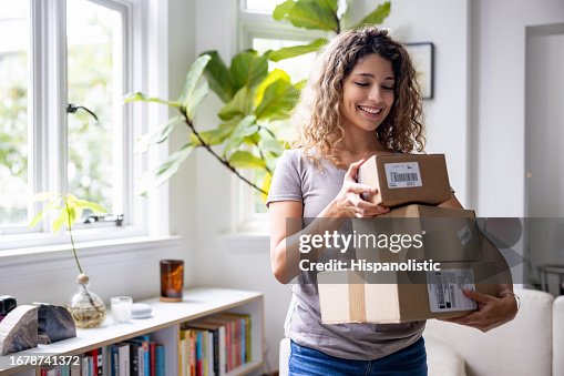 Happy woman at home receiving packages in the mail Happy woman at home receiving packages in the mail