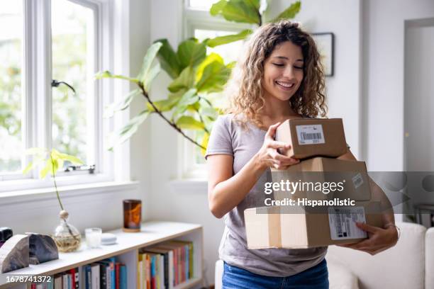 happy woman at home receiving packages in the mail - post office stock pictures, royalty-free photos & images