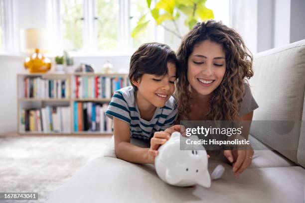 mother and son braking their piggybank - investment stock pictures, royalty-free photos & images