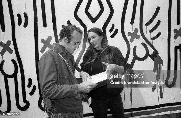 American artists Jenny Holzer and Keith Haring in front of theire installation for the Wiener Festwochen. Am Hof. Vienna. 1986. Photograph by Didi...