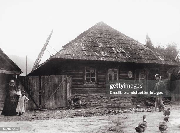 People in hungary celebrating the jewish festival of sukkot. The family turned their house into the traditional leaf hut. Photograph. About 1928....