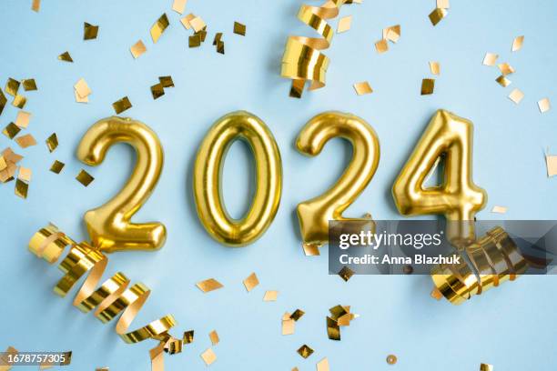 2024 new year number. golden digits and confetti over blue background. - happy new year ストックフォトと画像