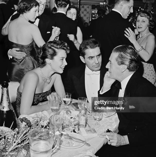 Actors Linda Christian , her husband Tyrone Power , and Ivor Novello meet for a drink at the Cafe de Paris in London, February 1951. Original...