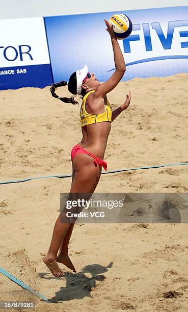 Maria Clara Salgado Rufino of Brazil serves against Barbara Hansel and Katharina Schutzenhofer of Austria during the women's qualification of FIVB...