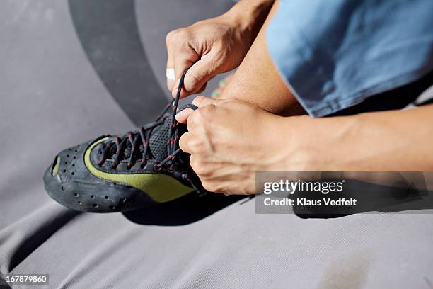 climber tying climbing shoe - form fitted stock pictures, royalty-free photos & images
