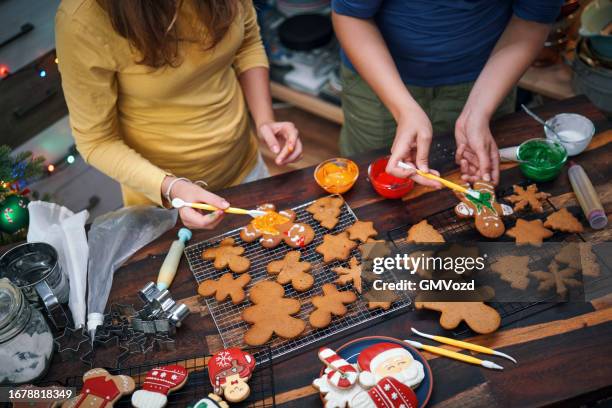 teenage girls trying to prepare christmas cookies in domestic kitchen - tag 11 stock pictures, royalty-free photos & images