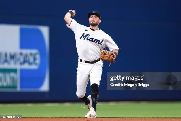 Garrett Hampson of the Miami Marlins throws to first base against the Los Angeles Dodgers during the second inning of the game at loanDepot park on...