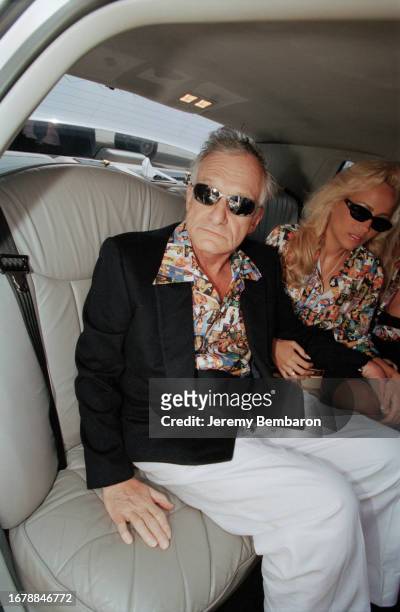 Hugh Hefner, the publisher of Playboy magazine, accompanied by his playmate Brande Roderick on 17 May 1999 in Paris.