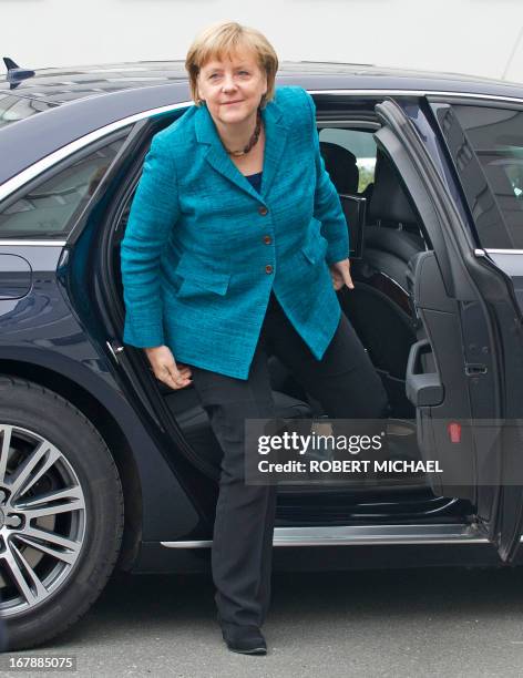 German Chancellor Angela Merkel gets off her car as she arrives for a visit at the Jena-Optronik GmbH , a provider of opto-electronic instruments and...