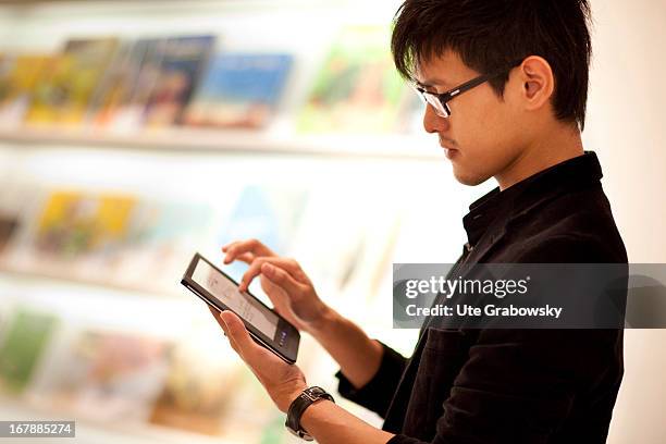 October 07: Male reader with Tablet PC at the Book Fair in Frankfurt.