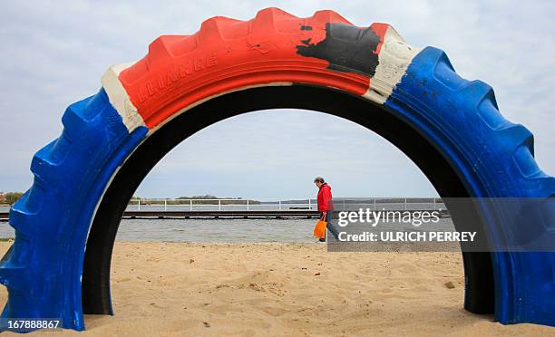 Woman walks at Schaalsee lake in Zarrentin, eastern Germany, on May 2, 2013. Meteorologists forecast mild temperatures for the coming week in eastern...