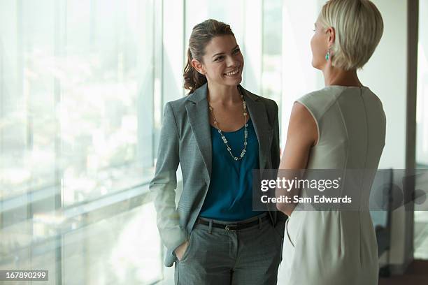 businesswomen talking in office - face to face stock pictures, royalty-free photos & images