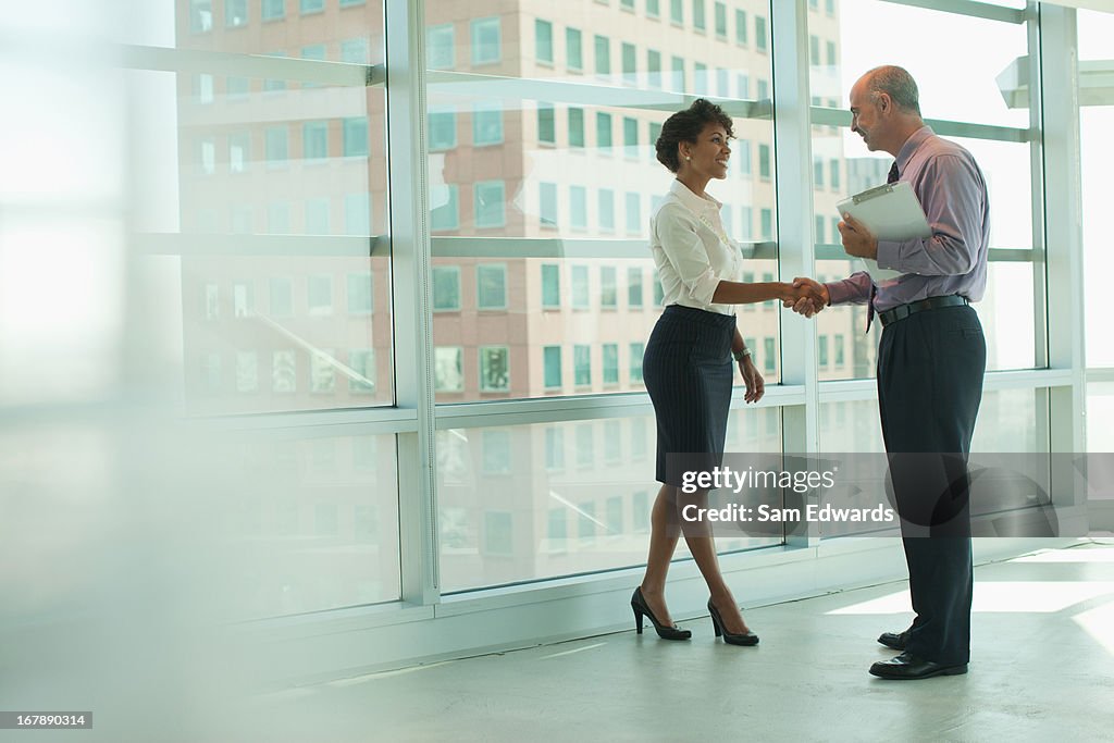 Business people shaking hands in office