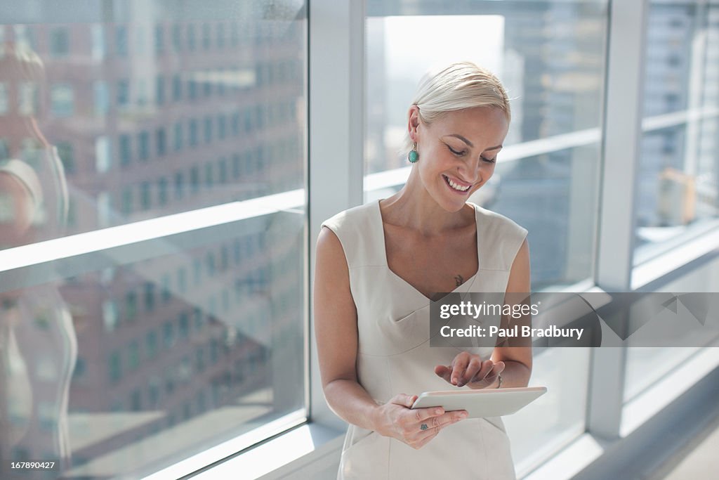 Businesswoman using tablet computer in office