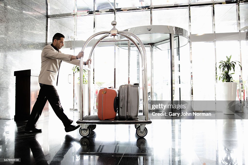 Bellboy pushing luggage trolley