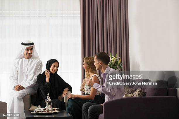 arab man chatting and sharing food with friends - ghoutra stock pictures, royalty-free photos & images