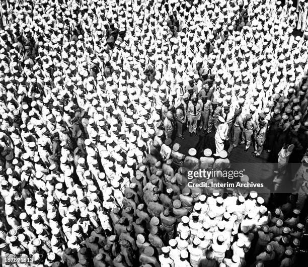 Elevated view of Admiral Lord Louis Mountbatten as he addresses crew members of the American aircraft carrier USS Saratoga, Tricomalee, Ceylon, April...