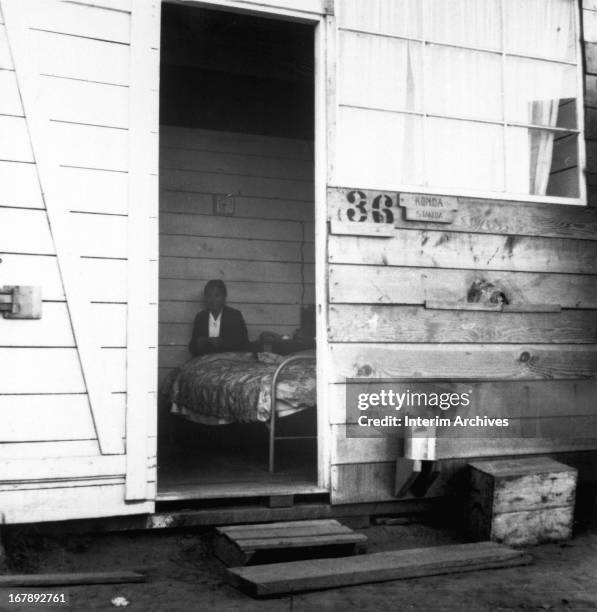 View through an open entrance of a family apartment at the Tanforan Assembly Center, a race track turned internment camp for Americans of Japanese...