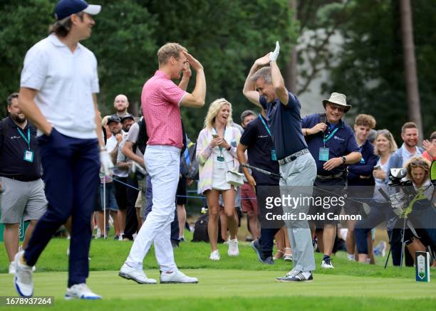 Anton du Beke of England the BBC Strictly Come Dancing dancer and judge celebrates with Dan Walker after hitting a long drive during the pro-am prior...