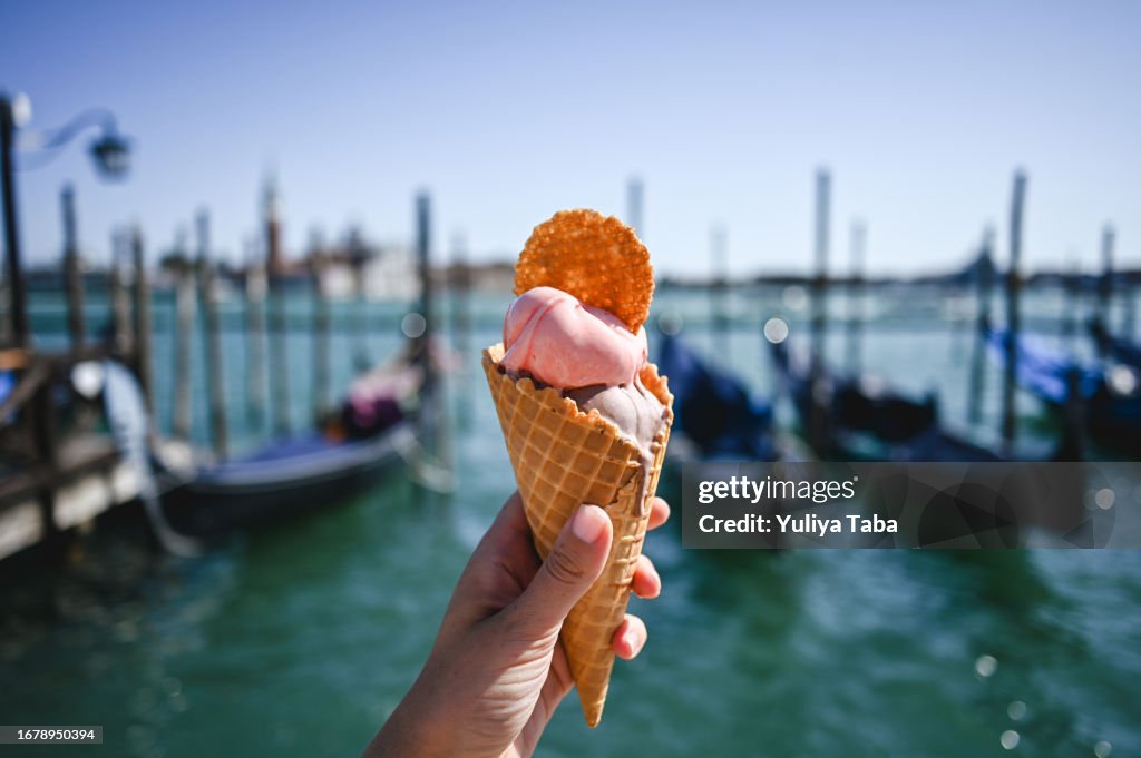 Italian gelato in waffle cone in front of San Marco canal in Venice.