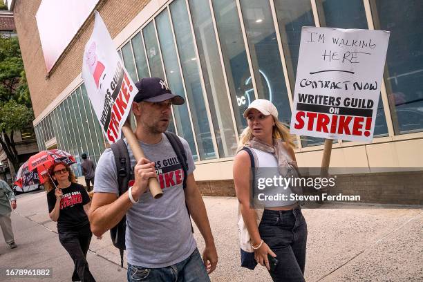 Actor Mikey Day and Next Found Artist founder Rachael Galperin join members of the Writers Guild of America walking a picket line outside of "The...