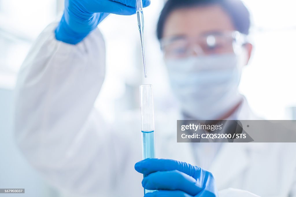 Lab researcher checking fluid in test tube