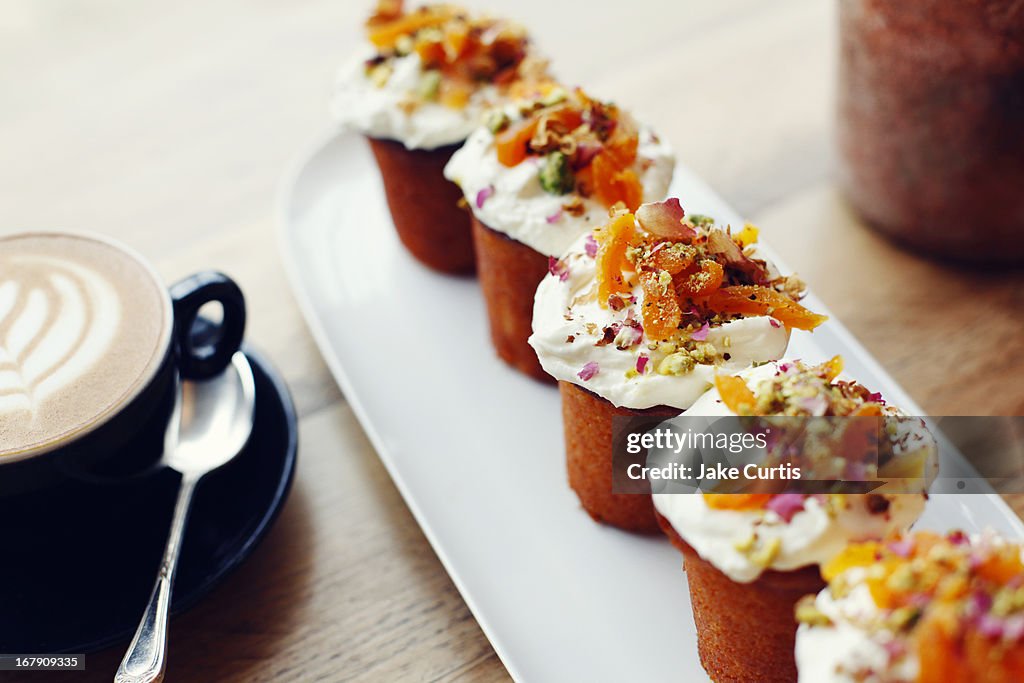 Tray of small cakes with colourful toppings