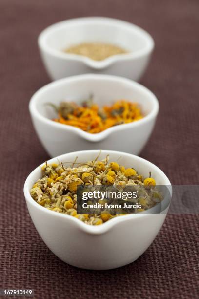 assorted organic tea in white bowls - corn marigold stock pictures, royalty-free photos & images
