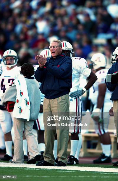 Coach John Mackovic of the Arizona Wildcats encourages his team from the sideline during the NCAA football game against the Washington Huskies at...