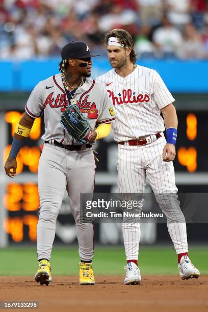 Ronald Acuna Jr. #13 of the Atlanta Braves and Bryce Harper of the Philadelphia Phillies speak during the first inning at Citizens Bank Park on...