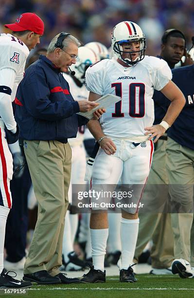 Arizona Wildcat coach John Mackovic discusses strategy with quarterback Jason Johnson during the NCAA football game against the Washington Huskies at...