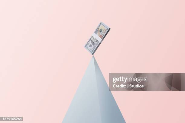 money bundle on top of pyramid shape - financial reward stock pictures, royalty-free photos & images