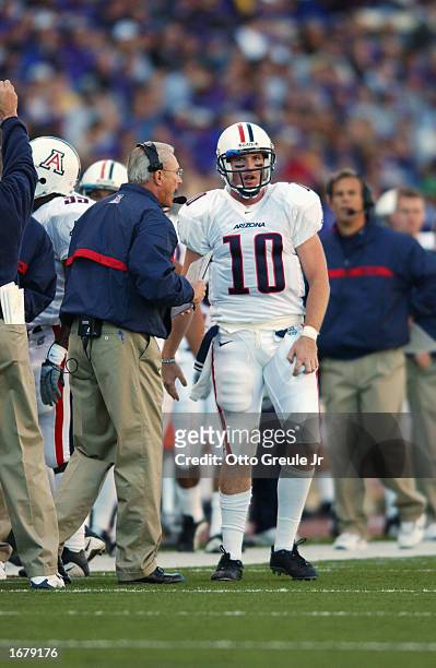 Quarterback Jason Johnson of the Arizona Wildcats talks with coach John Mackovic before taking the field during the NCAA football game against the...