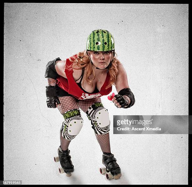 portrait of roller derby girl in arena, high view - roller derby foto e immagini stock