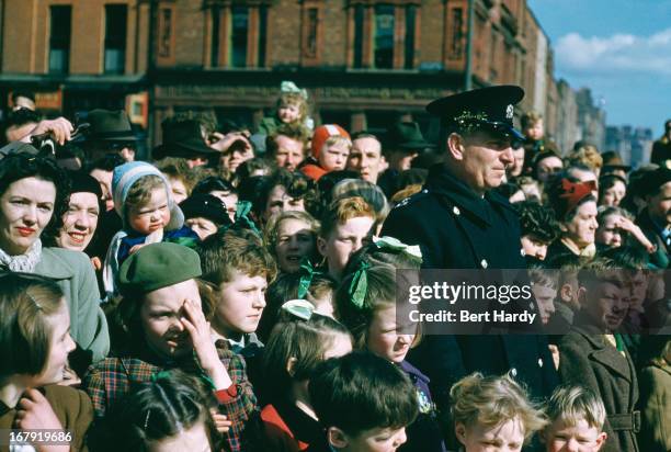 Crowd watching a St Patrick's Day street parade in Dublin, Eire, June 1955. Original publication: Picture Post - 7808 - Dublin - pub. 18th June 1955.