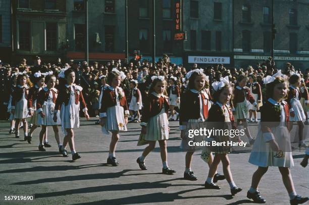 Group of girls in a St Patrick's Day street parade in Dublin, Eire, 17th March 1955. Original publication: Picture Post - 7808 - Dublin - pub. 18th...