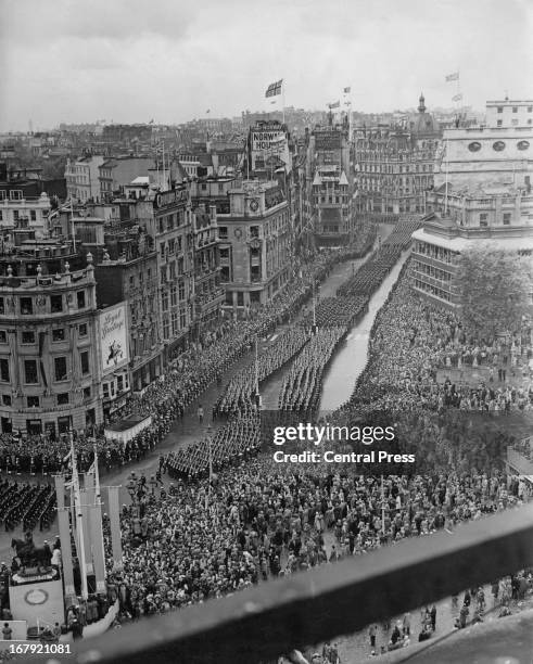 Crowds lining Trafalgar Square watch HRH Queen Elizabeth II's coronation procession passing, 2nd June 1953.