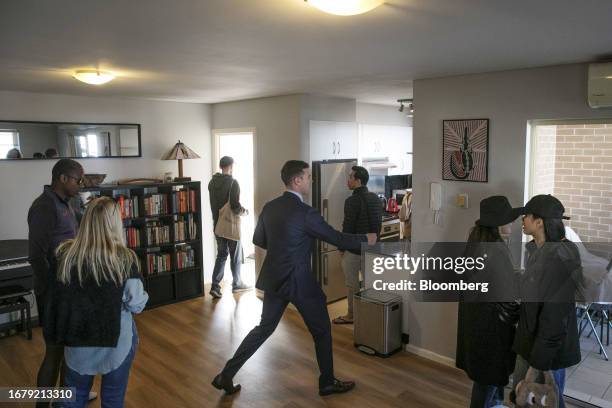 An agent attends to groups of potential tenants visiting an apartment unit for property inspection in Sydney, Australia, on Saturday, August 12,...