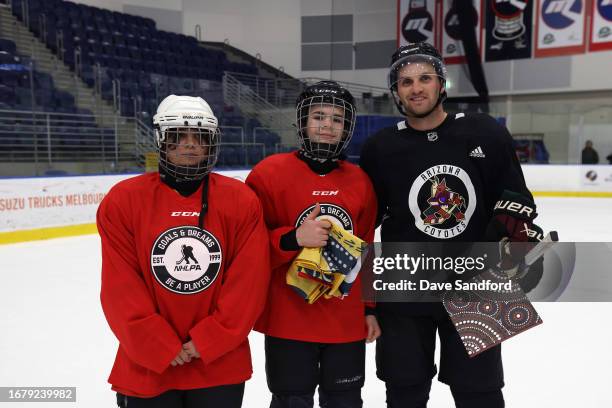 Participants in the Ice Hockey Australia Youth Clinic present Alex Kerfoot of the Arizona Coyotes with gifts at the O'Brien Icehouse as part of the...