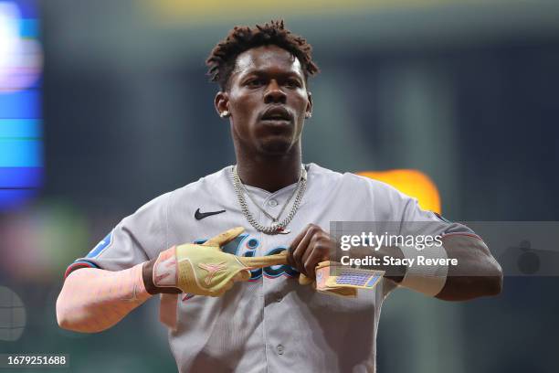Jazz Chisholm Jr. #2 of the Miami Marlins takes off his batting glovers during the fourth inning against the Milwaukee Brewers at American Family...