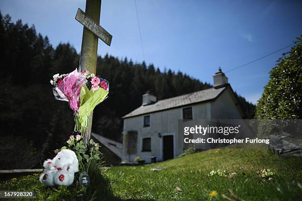 Teddybear and floral tributes adorn a post outside of the former home of defendant Mark Bridger in Ceinws, Mid Wales who is currently on trial for...