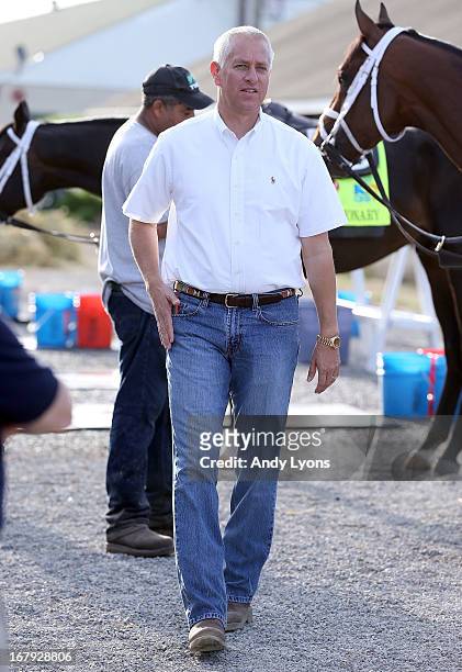Todd Pletcher watches his horses get prepared to go to the track during the morning training for the 2013 Kentucky Derby at Churchill Downs on May 2,...
